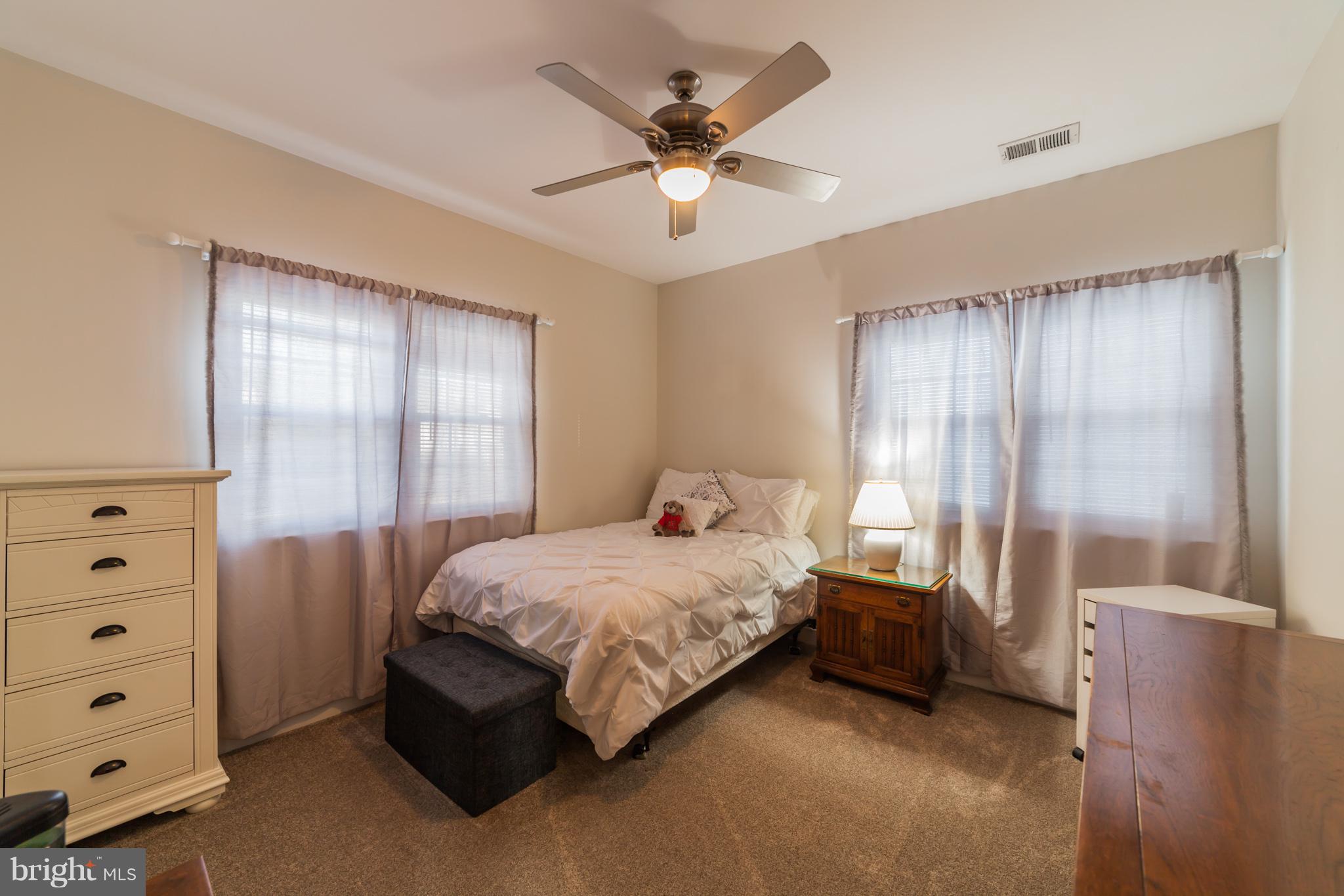 11704 Goodloe Road Silver Spring, MD 20906 - Photo 29 of 30 a spacious bedroom with a bed and a dresser