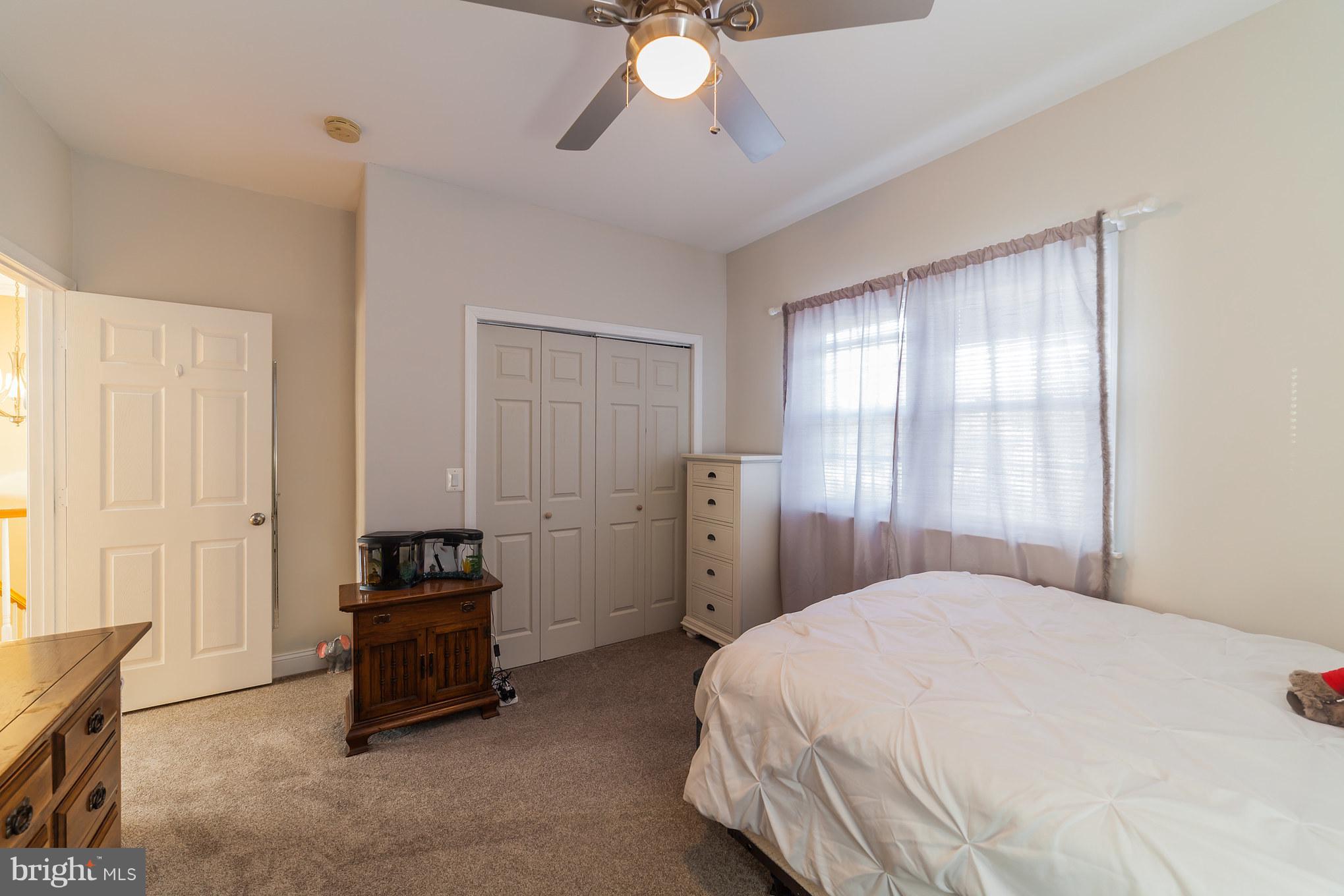 11704 Goodloe Road Silver Spring, MD 20906 - Photo 30 of 30 a spacious bedroom with a bed and a chandelier