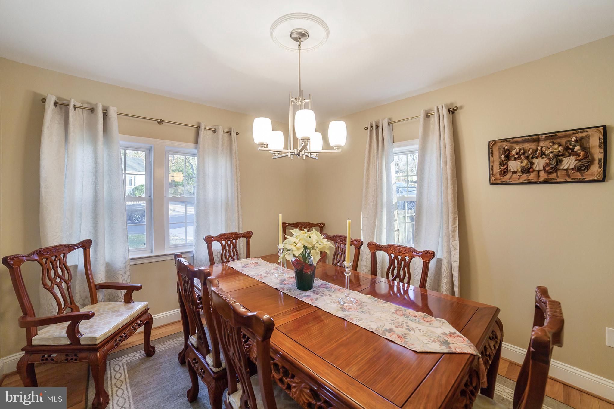 11704 Goodloe Road Silver Spring, MD 20906 - Photo 6 of 30 a view of a dining room with furniture and a chandelier