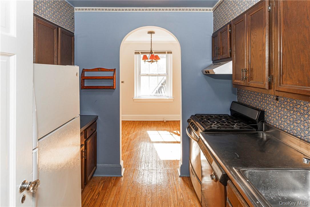 270 Bronxville Road, Unit B63 Bronxville, NY 10708 - Photo 12 of 25 a kitchen with a refrigerator a stove and wooden floor