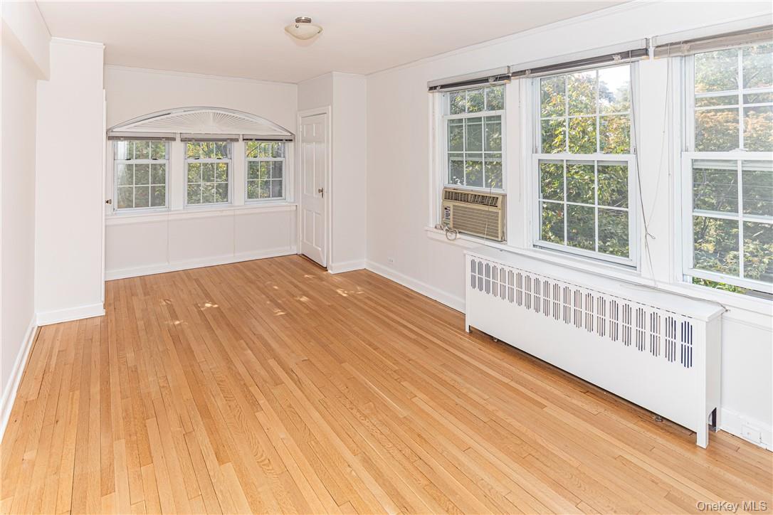 270 Bronxville Road, Unit B63 Bronxville, NY 10708 - Photo 15 of 25 a view of an empty room with wooden floor and windows