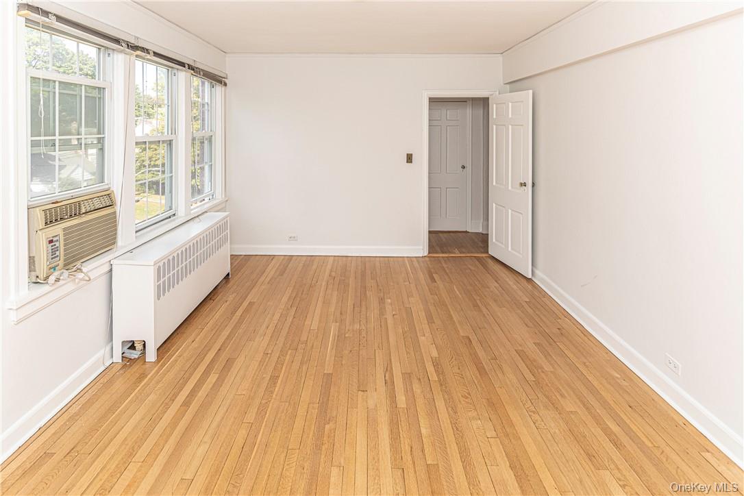 270 Bronxville Road, Unit B63 Bronxville, NY 10708 - Photo 16 of 25 a view of an empty room with wooden floor and a window