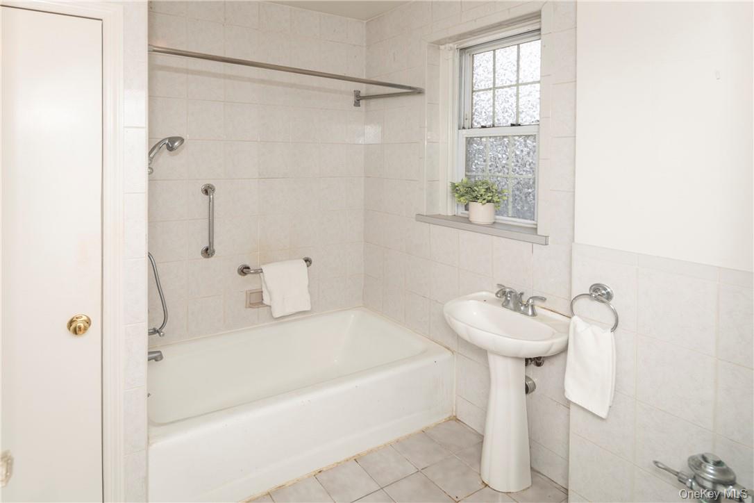 270 Bronxville Road, Unit B63 Bronxville, NY 10708 - Photo 19 of 25 a bathroom with a sink a toilet and shower