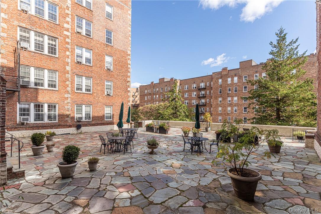270 Bronxville Road, Unit B63 Bronxville, NY 10708 - Photo 23 of 25 a view of a patio with a dining table and chairs