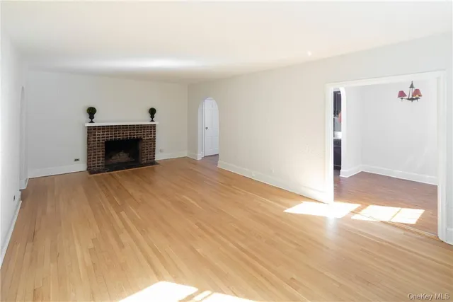 a room with a fireplace and a wooden floor
