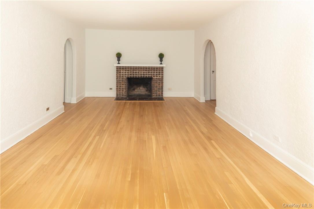 270 Bronxville Road, Unit B63 Bronxville, NY 10708 - Photo 6 of 25 a room with a fireplace and a wooden floor