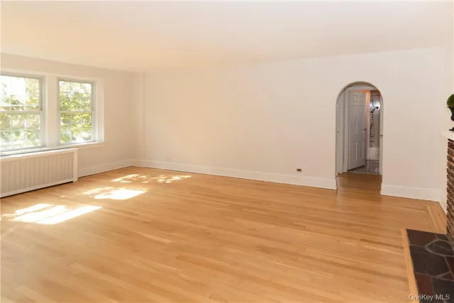 a very nice looking room with wooden floor and windows