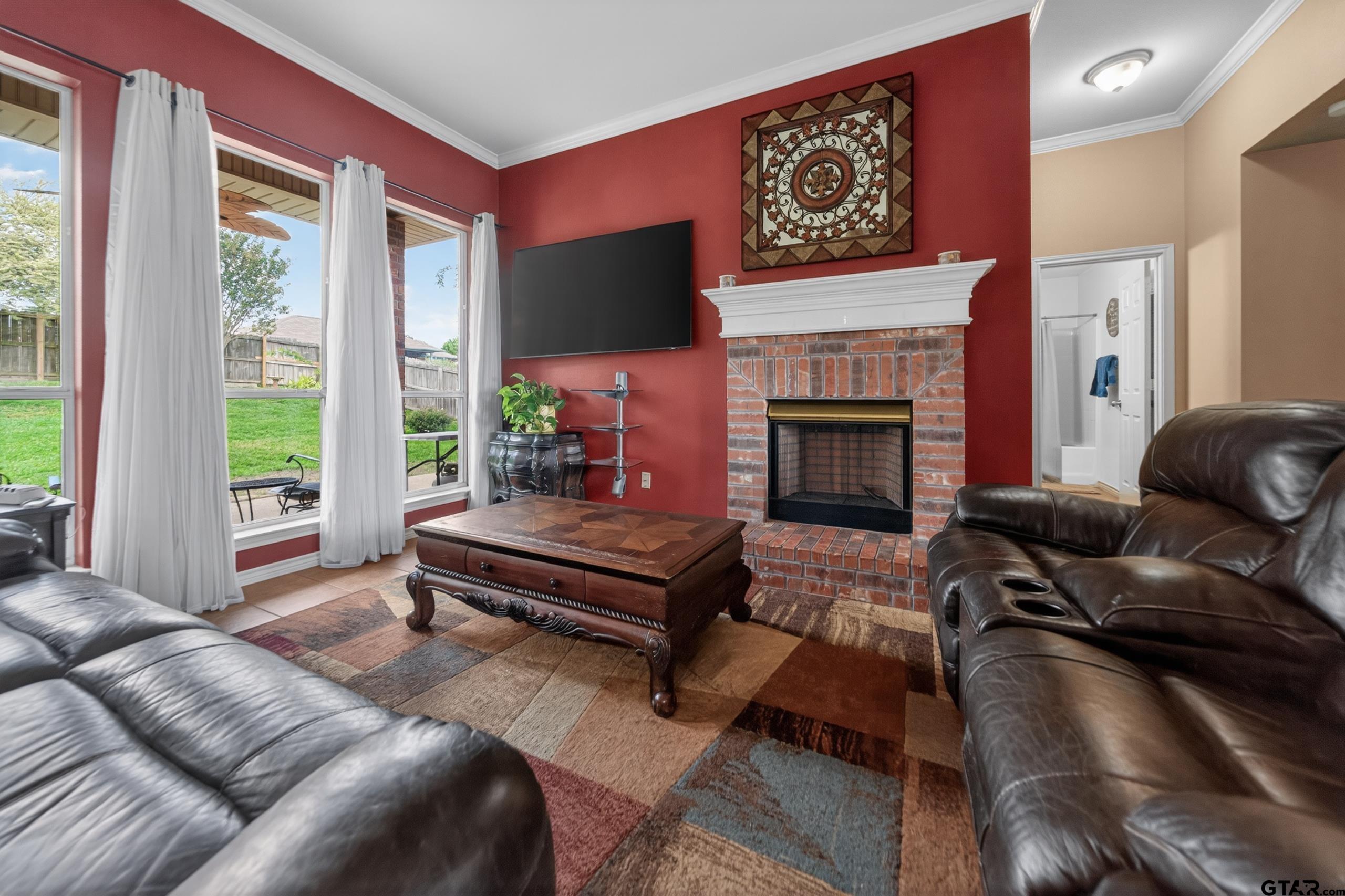 11274 Meadows Drive Flint, TX 75762 - Photo 15 of 43 a living room with furniture a flat screen tv and a fireplace