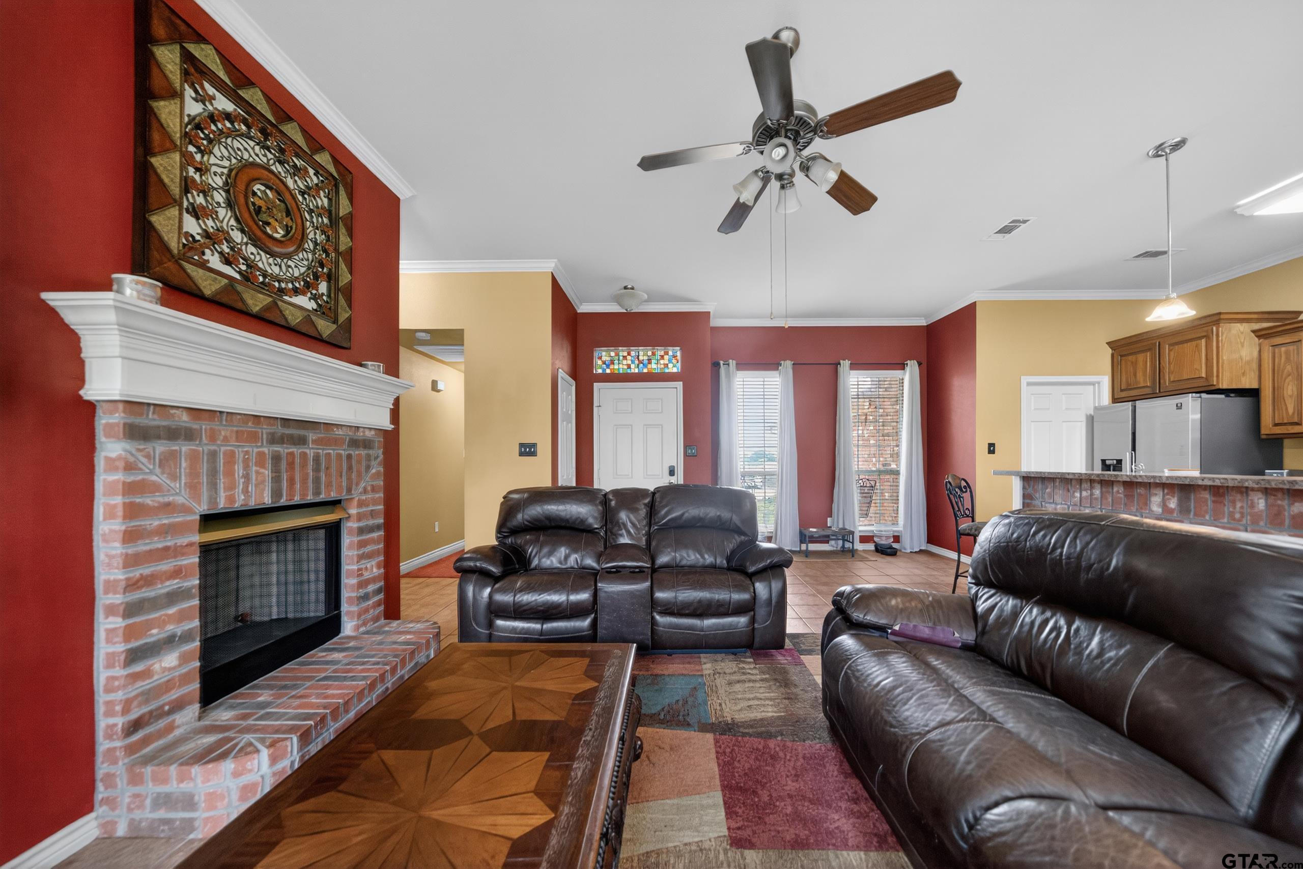 11274 Meadows Drive Flint, TX 75762 - Photo 17 of 43 a living room with furniture ceiling fan and a fireplace