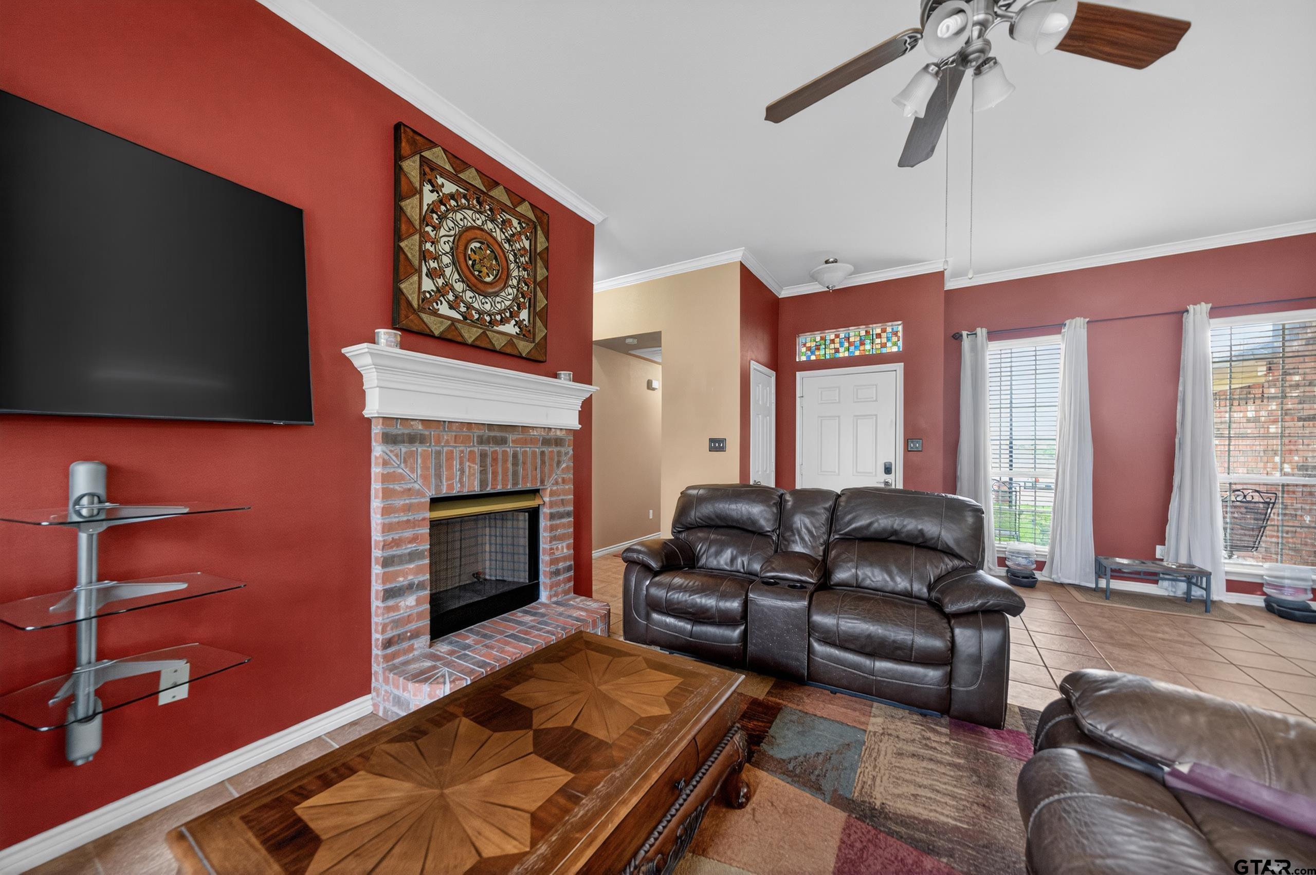 11274 Meadows Drive Flint, TX 75762 - Photo 18 of 43 a living room with furniture flat screen tv and a fireplace
