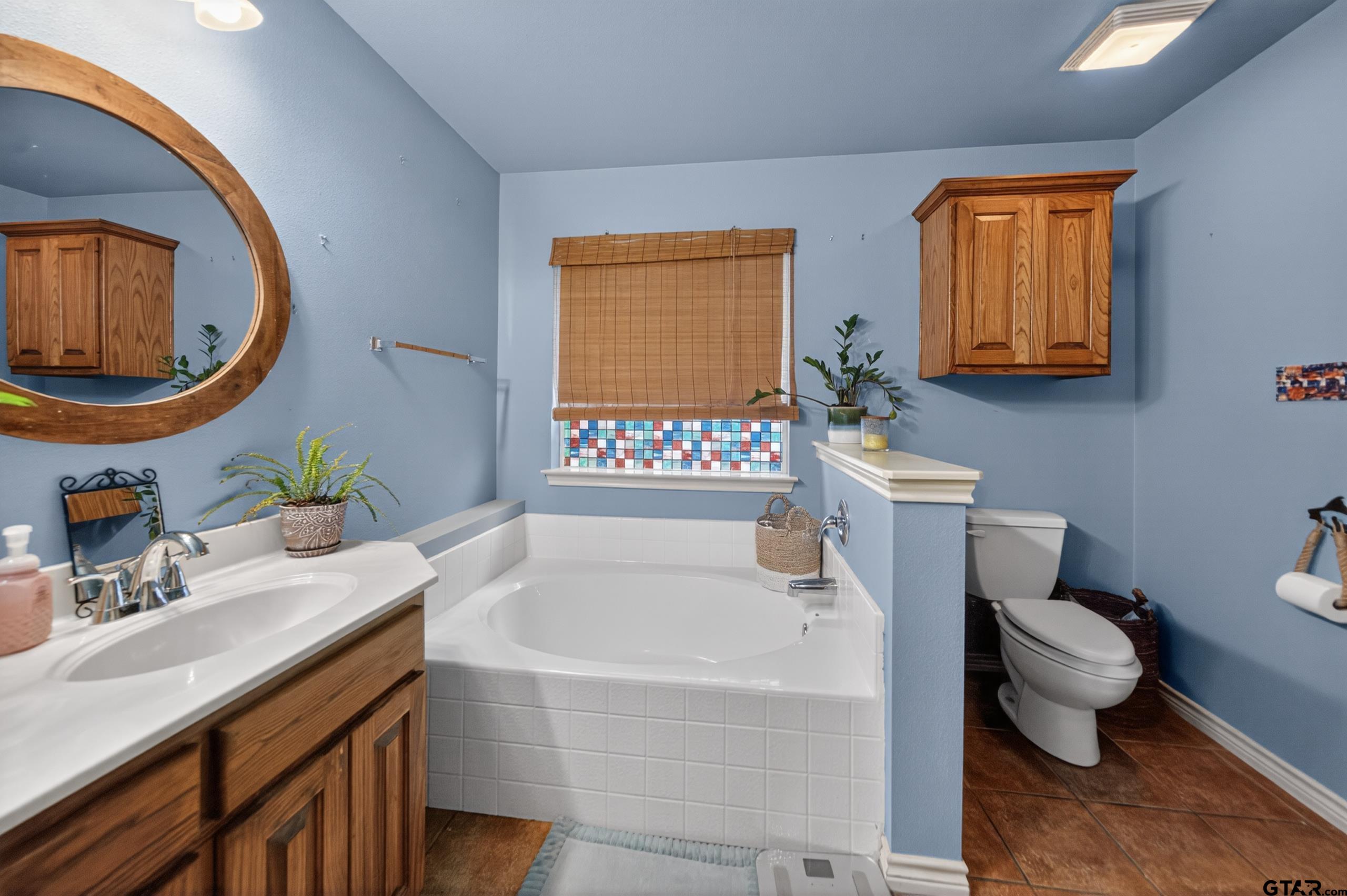 11274 Meadows Drive Flint, TX 75762 - Photo 19 of 43 a bathroom with a sink a toilet and a mirror