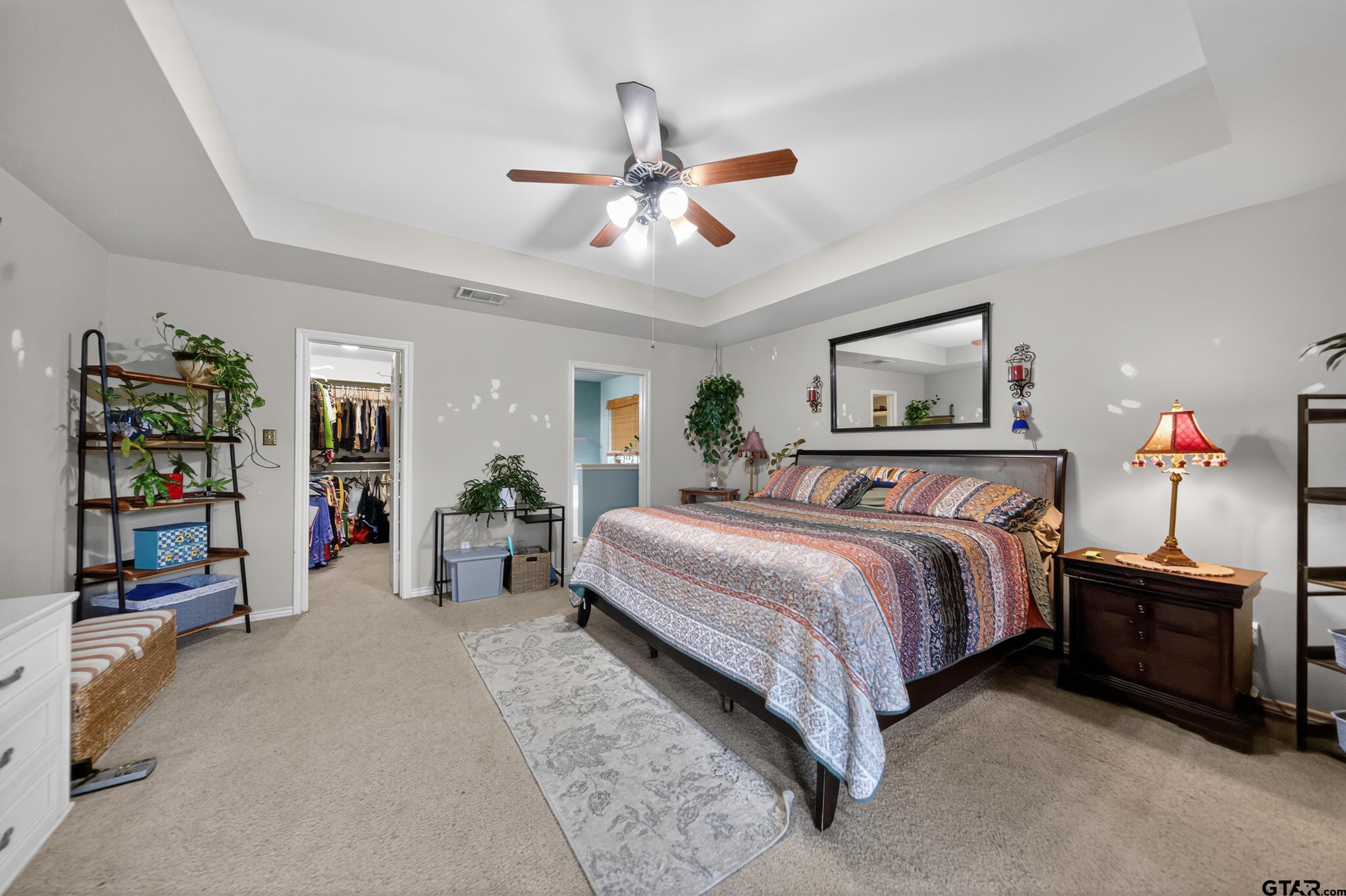 11274 Meadows Drive Flint, TX 75762 - Photo 24 of 43 a bedroom with bed and a chandelier