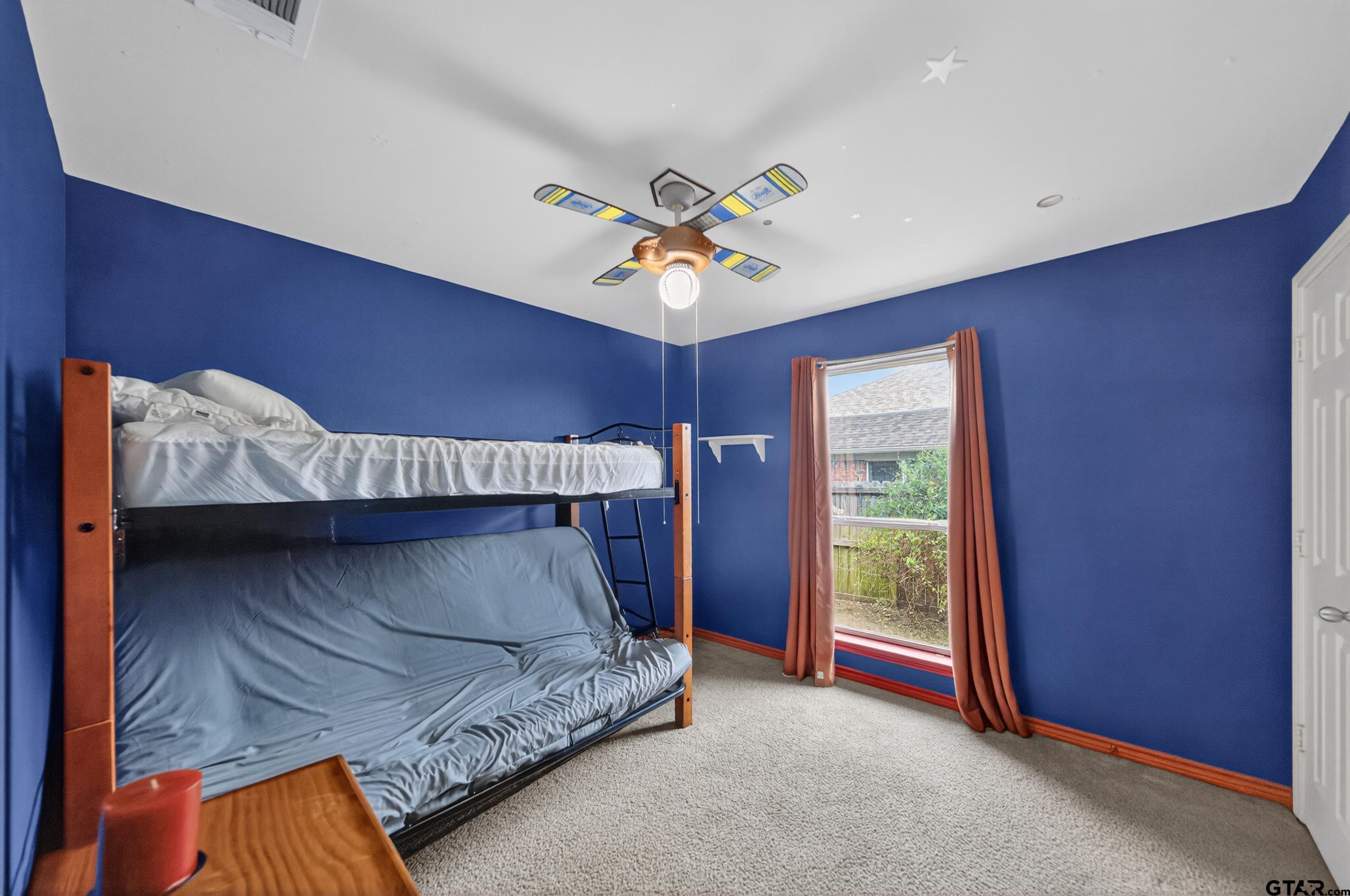 11274 Meadows Drive Flint, TX 75762 - Photo 28 of 43 a bed room with a bed and a chandelier