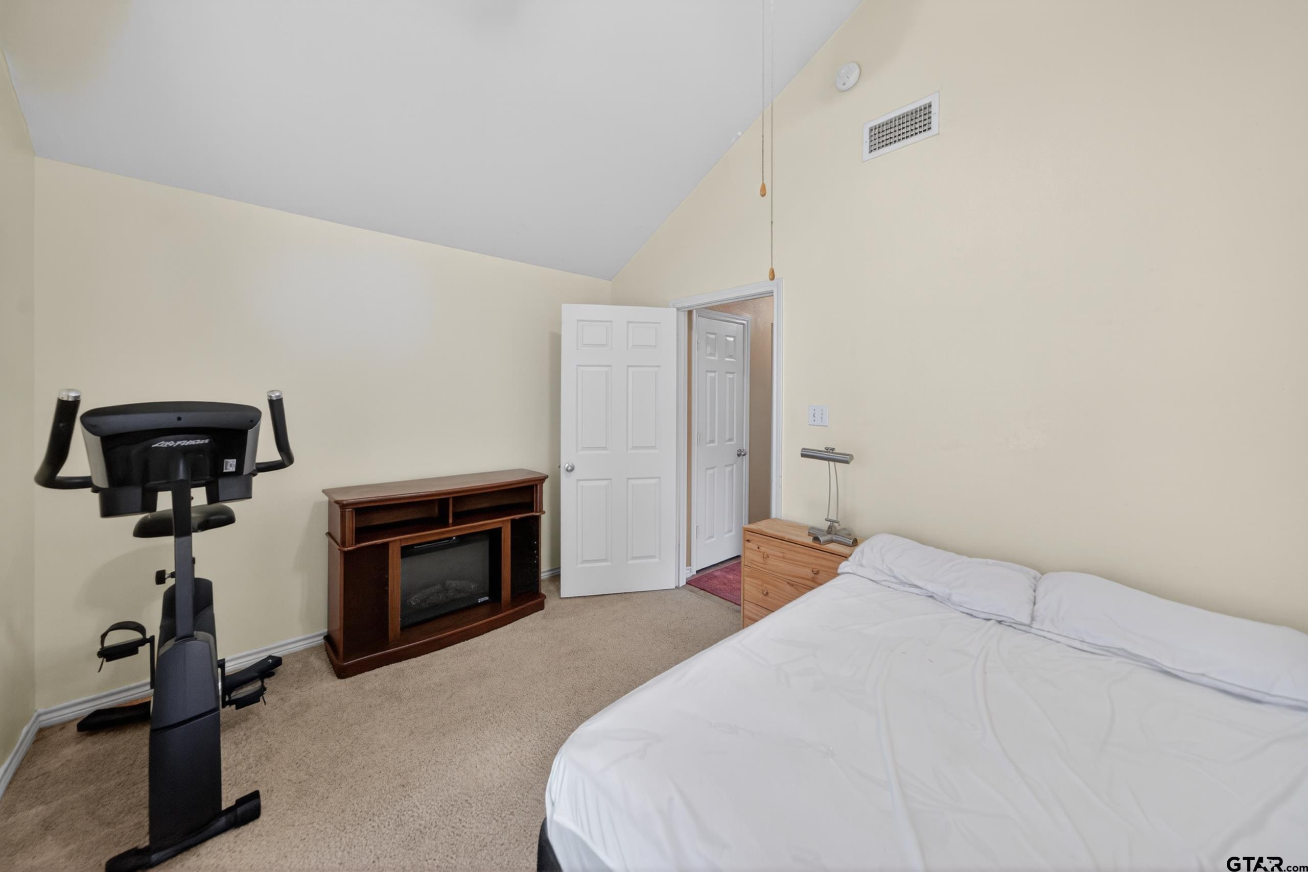 11274 Meadows Drive Flint, TX 75762 - Photo 32 of 43 a bedroom with a bed and a chandelier