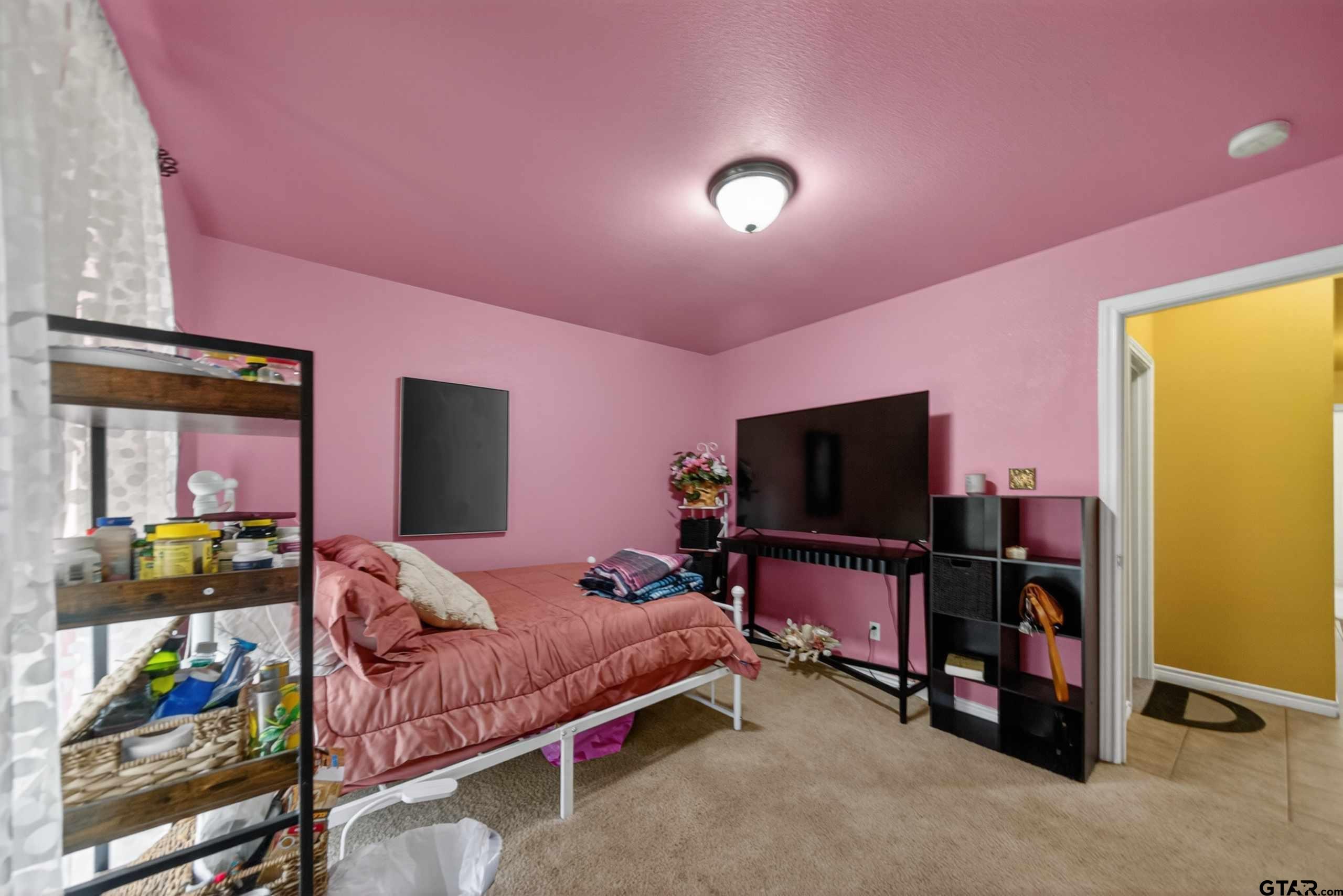 11274 Meadows Drive Flint, TX 75762 - Photo 38 of 43 a bedroom with a bed and a flat screen tv