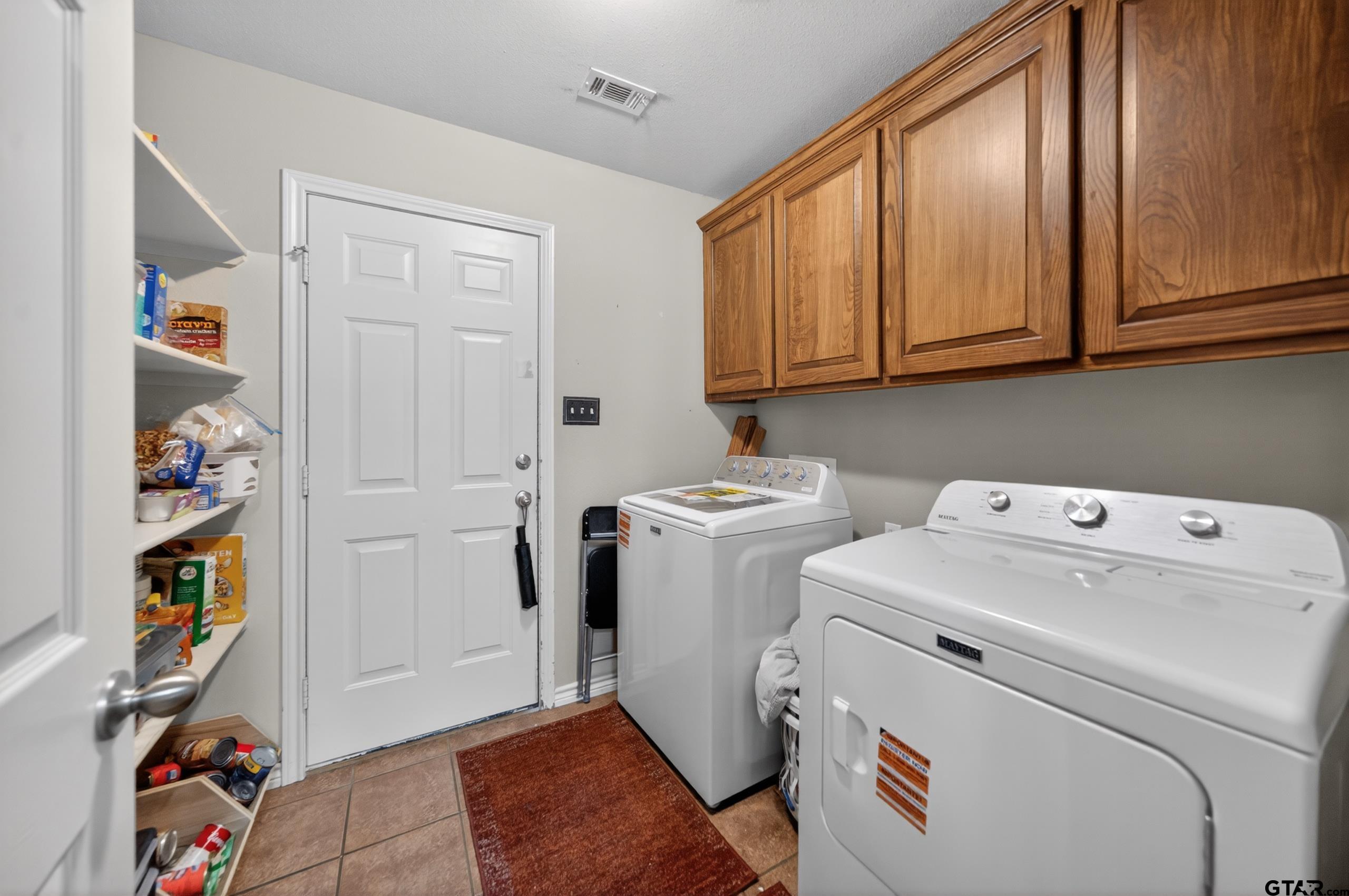 11274 Meadows Drive Flint, TX 75762 - Photo 4 of 43 a view of storage and utility room with washer and dryer