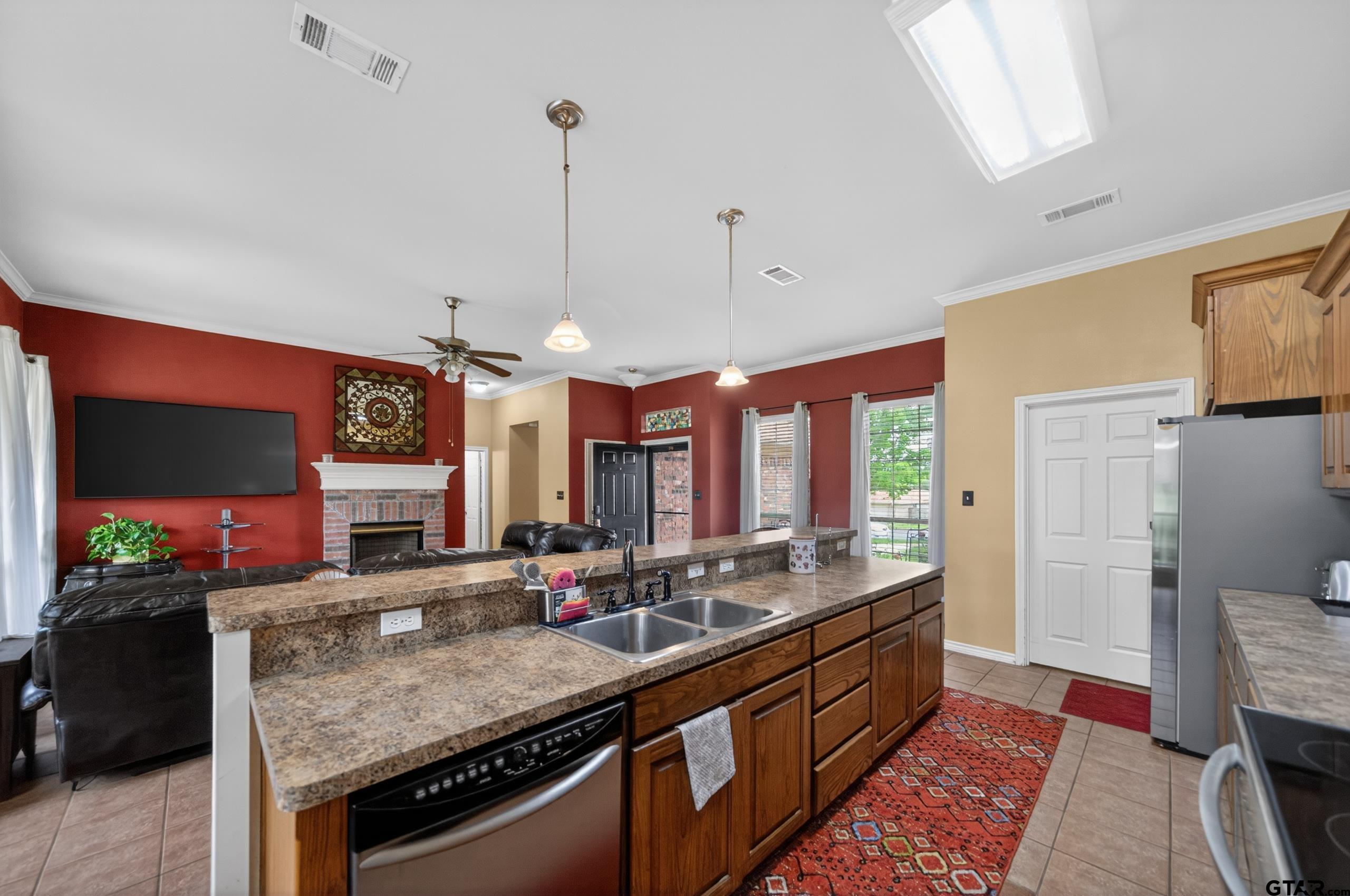 11274 Meadows Drive Flint, TX 75762 - Photo 8 of 43 a kitchen with stainless steel appliances granite countertop a sink a stove and a wooden floor