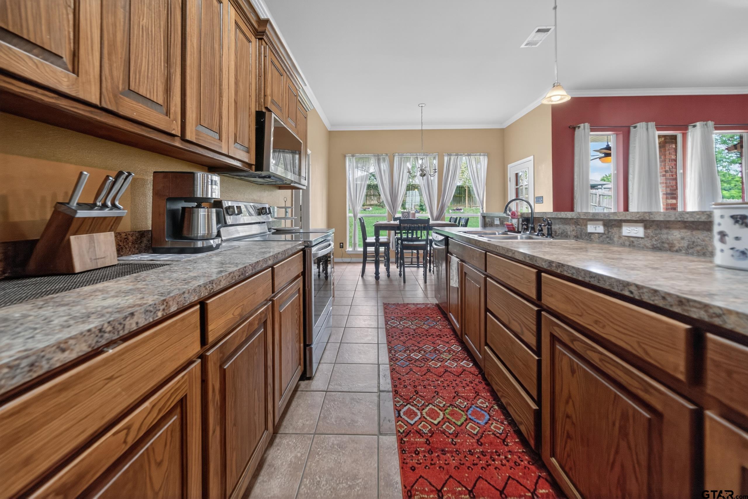 11274 Meadows Drive Flint, TX 75762 - Photo 10 of 43 a kitchen with granite countertop lots of counter top space and wooden floor