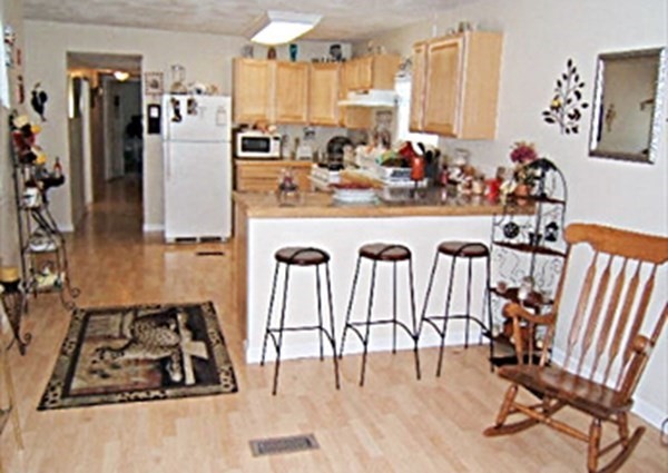 a view of a kitchen with kitchen island granite countertop lots of counter top space
