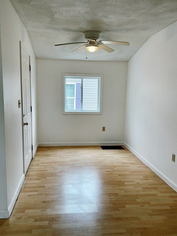 270 Littleton Road, Unit 109 Chelmsford, MA 01824 - Photo 11 of 41 a view of an empty room with wooden floor and a window