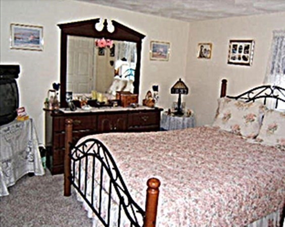 270 Littleton Road, Unit 109 Chelmsford, MA 01824 - Photo 14 of 41 a bed room with a bed mirror and a lamp on table