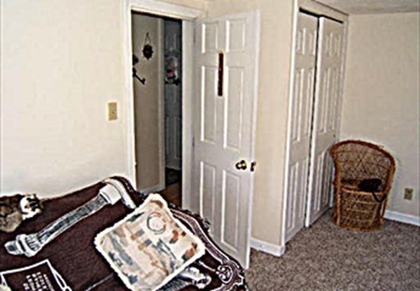 270 Littleton Road, Unit 109 Chelmsford, MA 01824 - Photo 15 of 41 a bedroom with a bed and a mirror