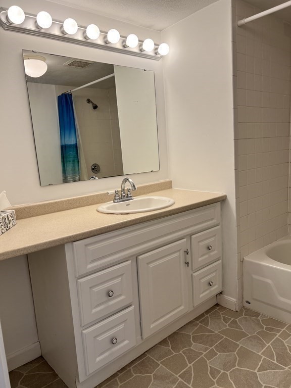 270 Littleton Road, Unit 109 Chelmsford, MA 01824 - Photo 23 of 41 a bathroom with a sink vanity and mirror
