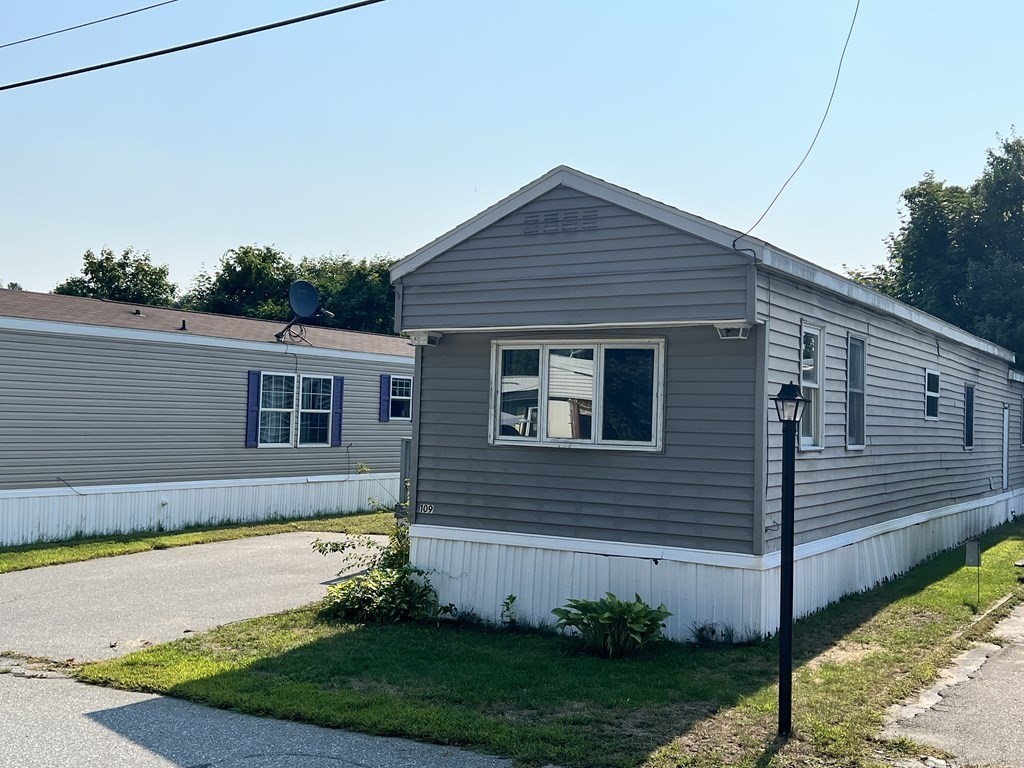 270 Littleton Road, Unit 109 Chelmsford, MA 01824 - Photo 28 of 41 a house view with a backyard space