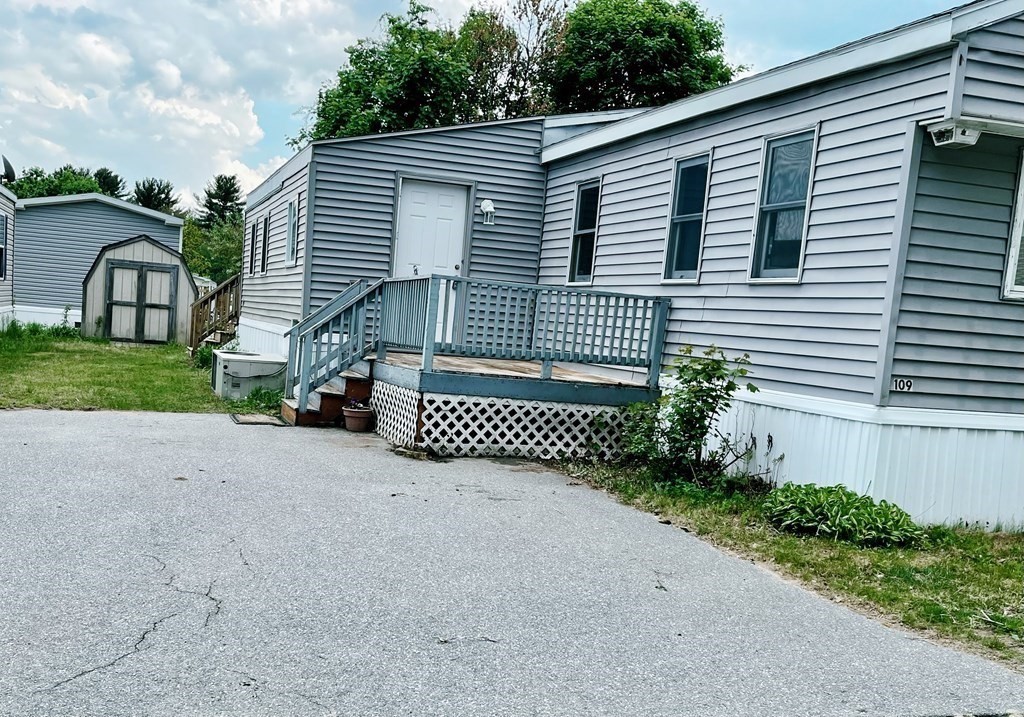 270 Littleton Road, Unit 109 Chelmsford, MA 01824 - Photo 29 of 41 a view of a house with a yard and garage