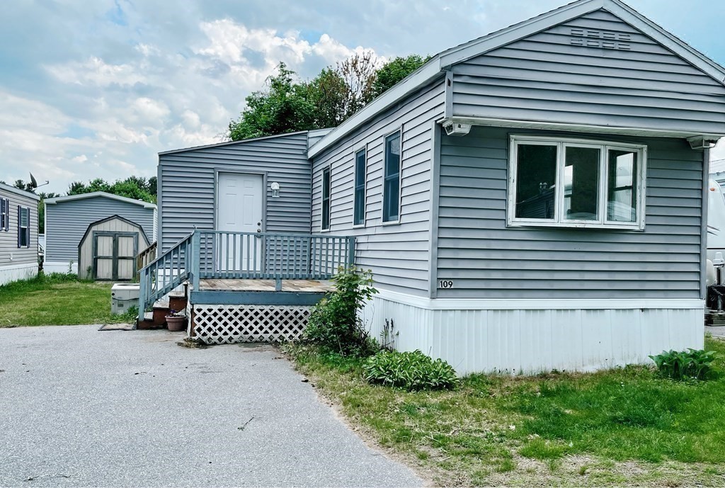 270 Littleton Road, Unit 109 Chelmsford, MA 01824 - Photo 30 of 41 a front view of a house with garden