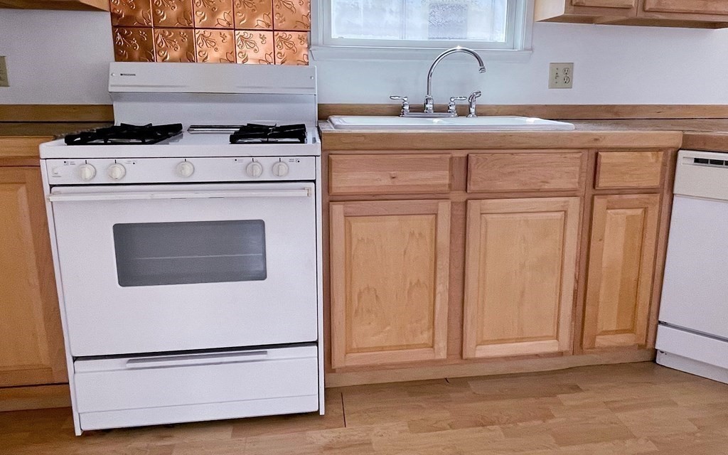 270 Littleton Road, Unit 109 Chelmsford, MA 01824 - Photo 5 of 41 a kitchen with granite countertop white cabinets and white appliances
