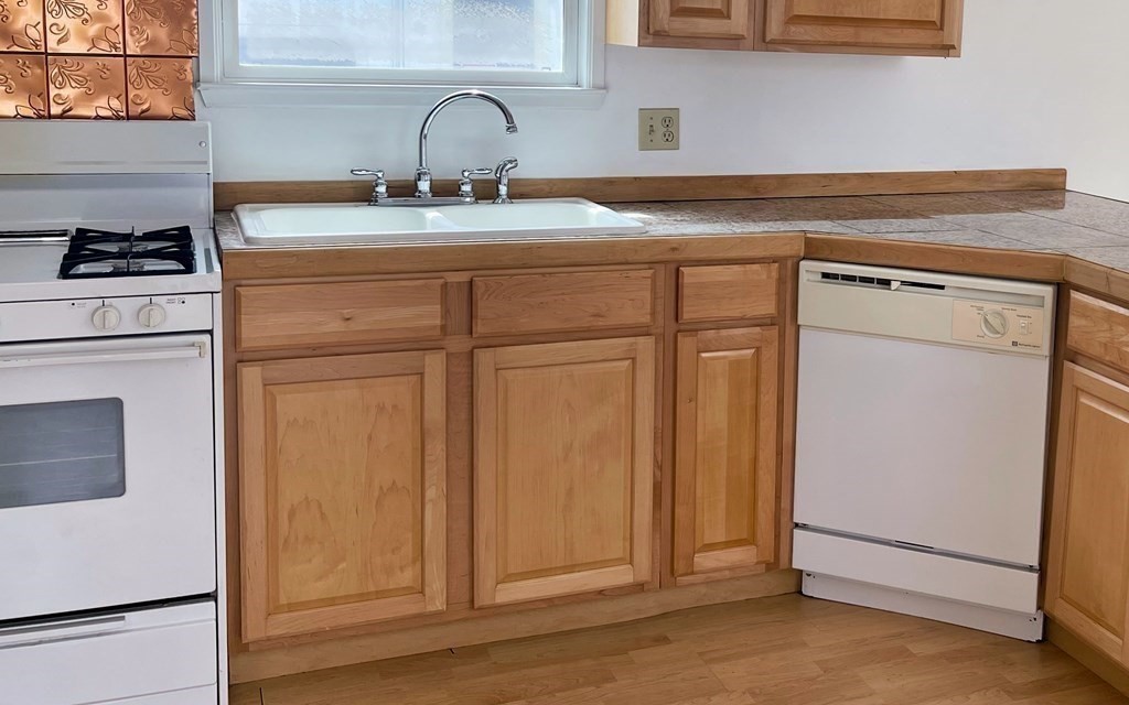270 Littleton Road, Unit 109 Chelmsford, MA 01824 - Photo 6 of 41 a kitchen with a sink and cabinets