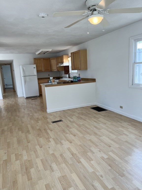 270 Littleton Road, Unit 109 Chelmsford, MA 01824 - Photo 8 of 41 a view of a kitchen with kitchen island stainless steel appliances wooden floor and a counter top space