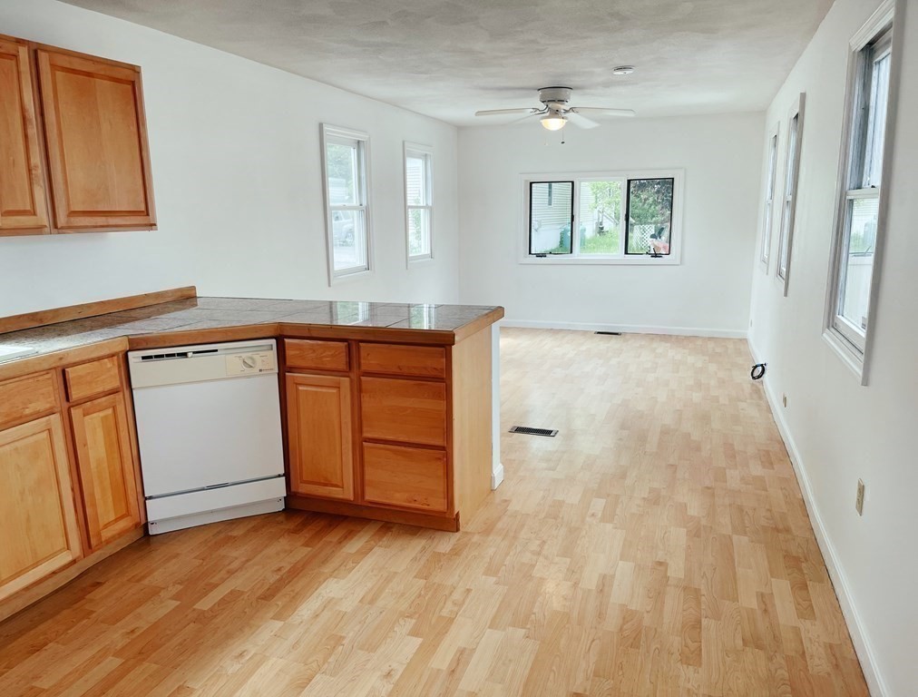 270 Littleton Road, Unit 109 Chelmsford, MA 01824 - Photo 9 of 41 a view of a kitchen with wooden floor and a sink