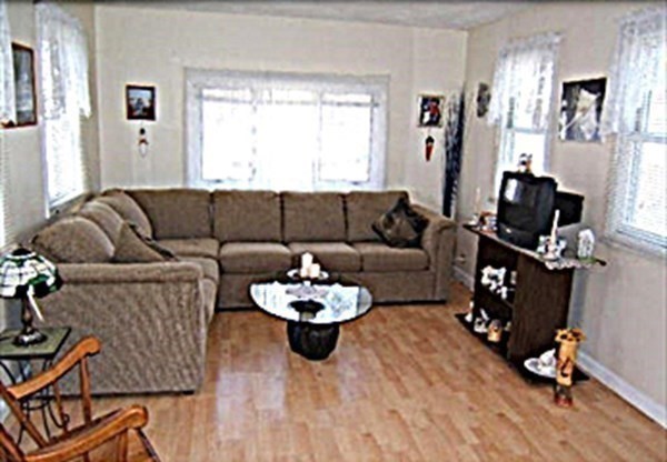 270 Littleton Road, Unit 109 Chelmsford, MA 01824 - Photo 10 of 41 a living room with furniture and wooden floor