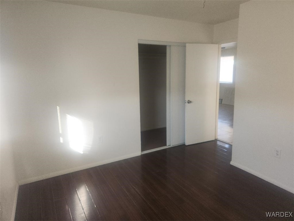 352 Rio Grande Court Bullhead City, AZ 86442 - Photo 13 of 14 an empty room with wooden floor and windows