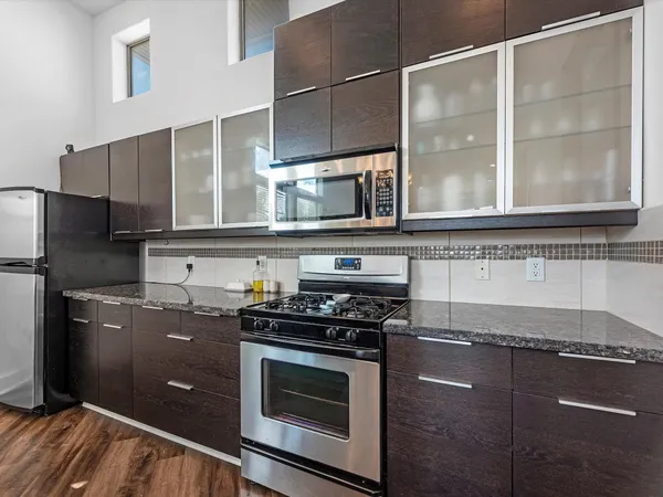 a view of a chairs setting in the backyard of a house