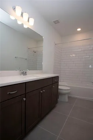 a yellow house with trees in front of it