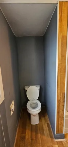 a view of a balcony with wooden floor and furniture