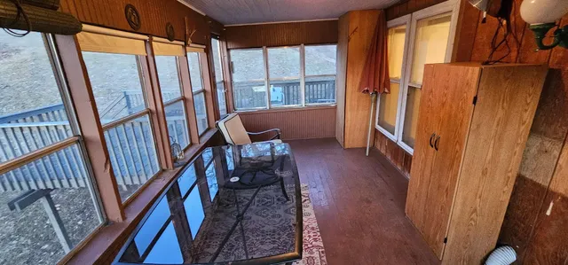 a view of a balcony with a pot on the wall