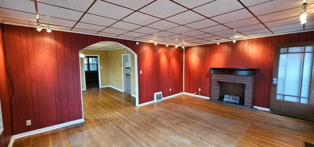 a view of a livingroom with wooden floor and a cabinet