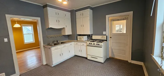 a kitchen with stainless steel appliances a stove and a window