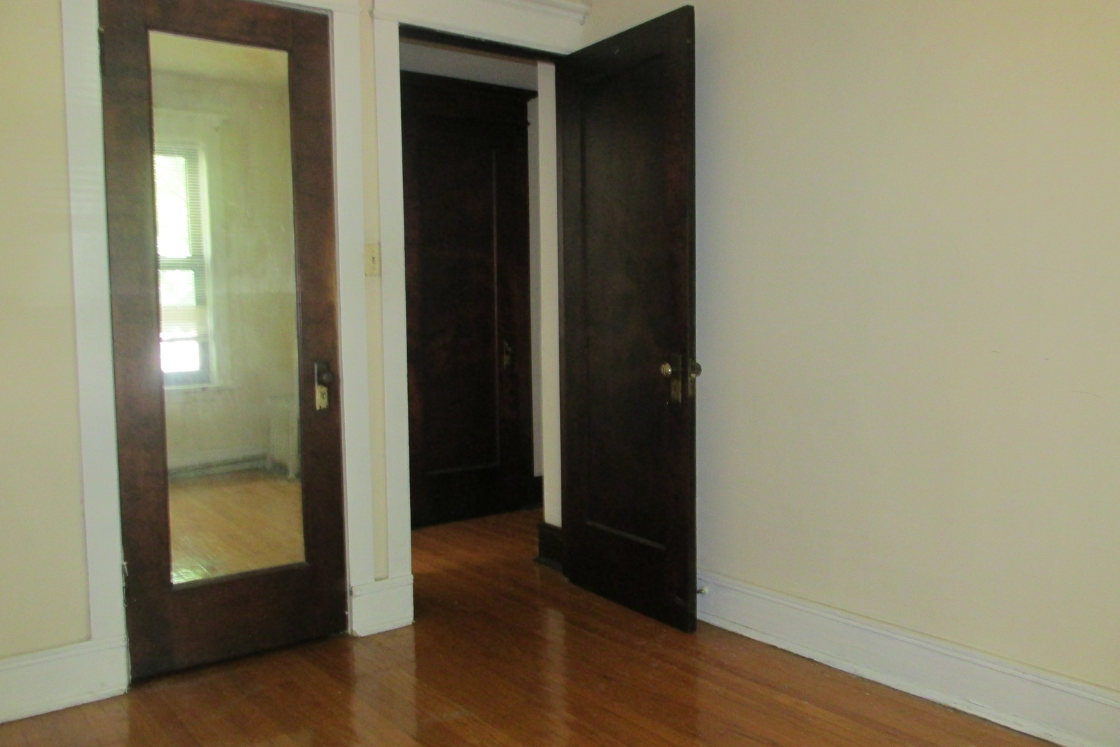 1367 East 56th Street, Unit 2 Chicago, IL 60637 - Photo 6 of 8 an empty room with wooden floor and closet