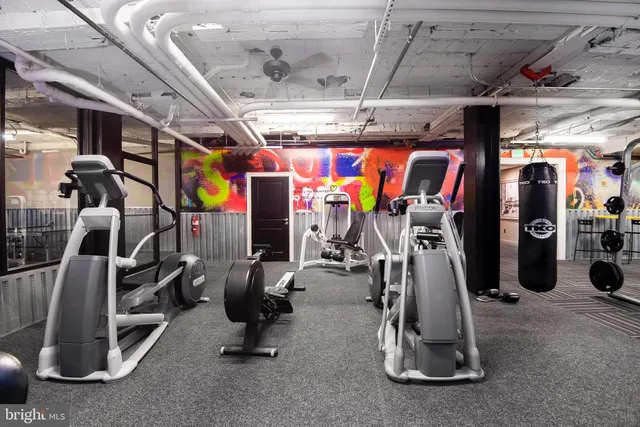 a room with stainless steel appliances and chandelier