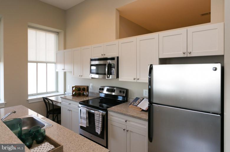 301 North Charles Street, Unit 1BR Baltimore, MD 21202 - Photo 45 of 48 a kitchen with a refrigerator stove and microwave