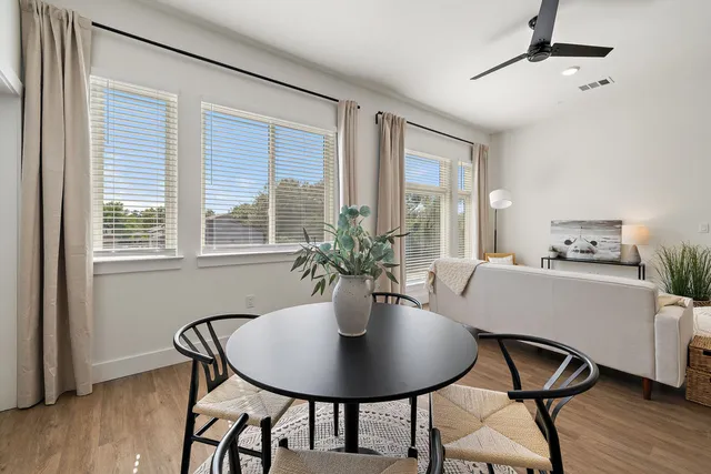 a dining room with furniture and window