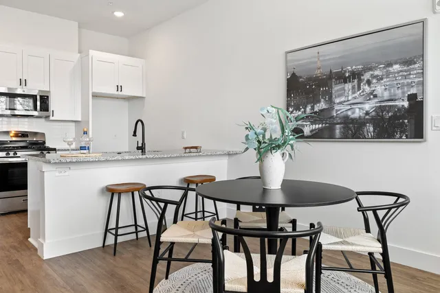 a dining room with furniture and wooden floor