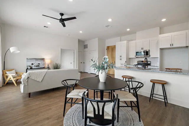 a living room with furniture and a wooden floor