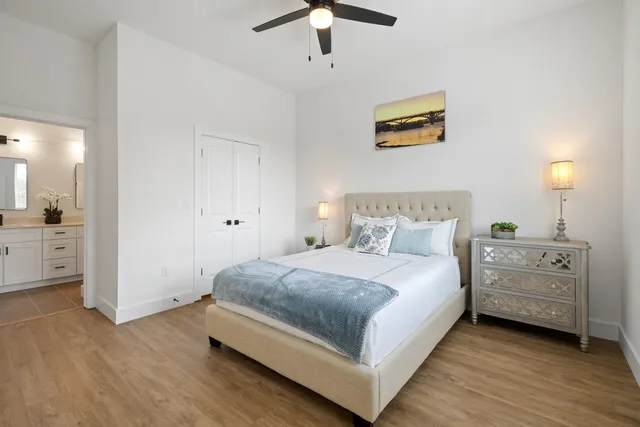 a spacious bedroom with a bed and a chandelier