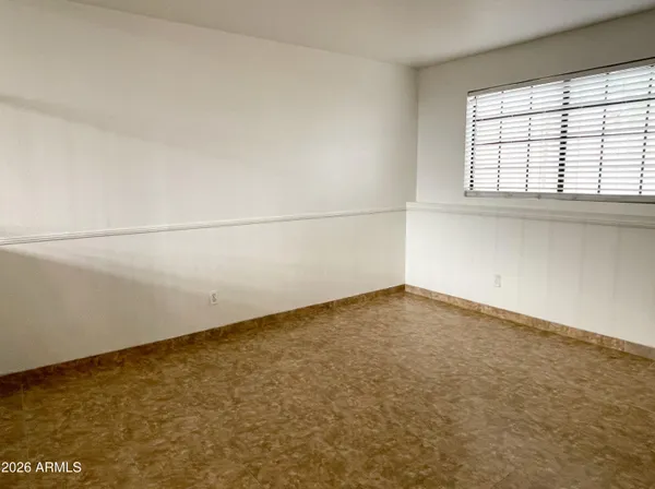 an empty room with a empty space and windows